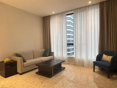 a living room with a couch and a chair and a window at Pavilion Ceylon Hill Luxury apartment Bukit Bintang by cupidhome in Kuala Lumpur