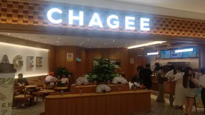 a chinese restaurant with people standing in the lobby at QUILL RESIDENCE by ASHNAS in Kuala Lumpur