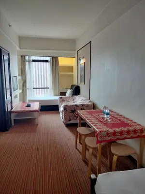 a hotel room with a bed and a table at Night suite apartment at time square kl in Kuala Lumpur