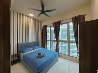 a bedroom with a teddy bear sitting on a bed at Spacious Family 2BR Balcony Comfy Regalia Suites in Kuala Lumpur