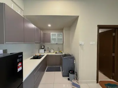a small kitchen with a sink and a refrigerator at Spacious Family 2BR Balcony Comfy Regalia Suites in Kuala Lumpur