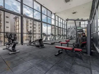 a gym with several tread machines in a large building at Family Suites Reizz Ampang 2R2B in Kuala Lumpur