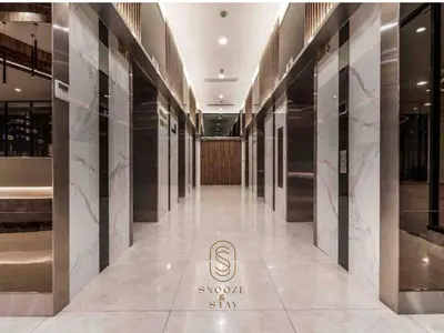 a hallway of a building with marble floors and walls at Family Suites Reizz Ampang 2R2B in Kuala Lumpur