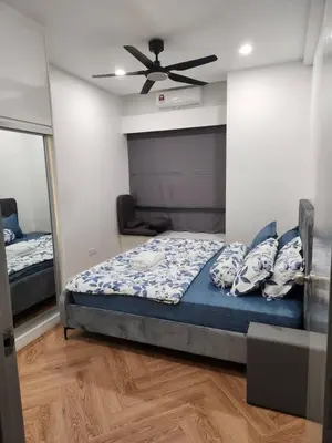 a bedroom with a bed and a ceiling fan at Yasemin Homestay in Kuala Lumpur