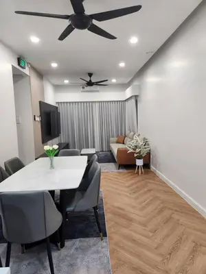 a living room with a table and a ceiling fan at Yasemin Homestay in Kuala Lumpur