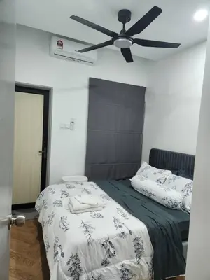a bedroom with a bed with a ceiling fan at Yasemin Homestay in Kuala Lumpur