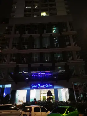 a building with a sign in front of it at night at Seri Bukit Ceylon in Kuala Lumpur