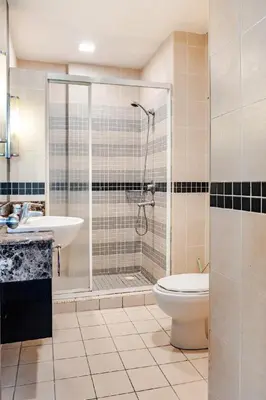 a bathroom with a shower and a toilet and a sink at Seri Bukit Ceylon in Kuala Lumpur