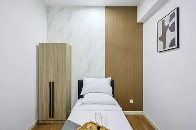 a bedroom with a bed with a purse on it at Stylish M Vertica 3 Bedroom Walk to MRT Velocity Mall in Kuala Lumpur