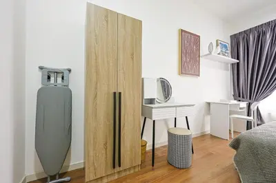 a room with a refrigerator and a desk in it at Stylish M Vertica 3 Bedroom Walk to MRT Velocity Mall in Kuala Lumpur