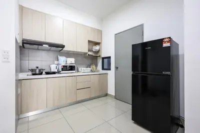 a kitchen with a black refrigerator and cabinets at Stylish M Vertica 3 Bedroom Walk to MRT Velocity Mall in Kuala Lumpur