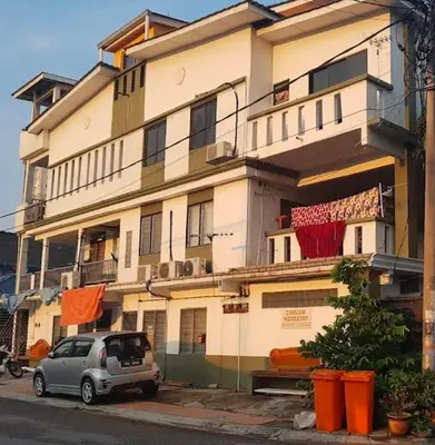 a car parked in front of a building at Zam Zam Homestay in Kuala Lumpur