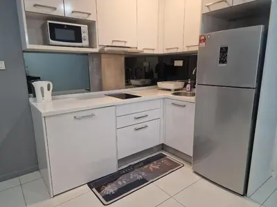a kitchen with a refrigerator and a microwave at Studio in Kuala Lumpur