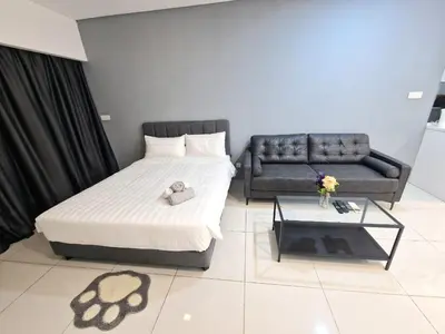 a bedroom with a bed and a couch and a table at Studio in Kuala Lumpur