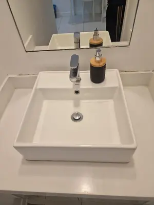 a white sink in a bathroom with a mirror at Studio in Kuala Lumpur