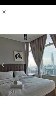 a bedroom with a bed with a large window at Sky Suite By SmartWill Properties in Kuala Lumpur