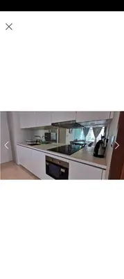 a kitchen with white cabinets and a stove at Sky Suite By SmartWill Properties in Kuala Lumpur