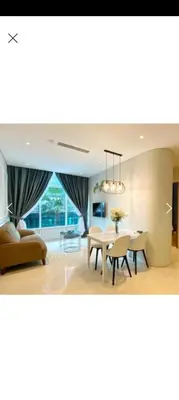 a dining room and living room with a table and chairs at Sky Suite By SmartWill Properties in Kuala Lumpur