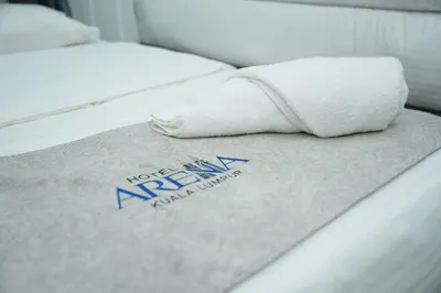 a bed with a towel on top of it at Arena Suites Kuala Lumpur in Kuala Lumpur