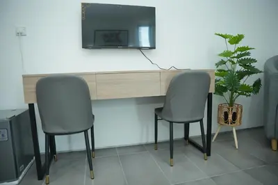 two chairs sitting next to a desk with a mirror at Arena Suites Kuala Lumpur in Kuala Lumpur
