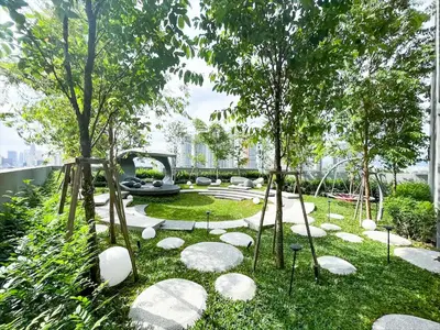 a garden with rocks and trees and a fountain at Scarletz Suite KLCC By Light House 4 in Kuala Lumpur
