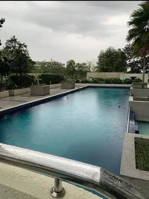 a large pool of blue water in a building at Flora Residency Setapak in Kuala Lumpur