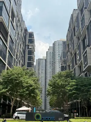 a bus is parked in front of tall buildings at Arcoris SOHO Mont Kiara 2B2B, Home Stay in Kuala Lumpur