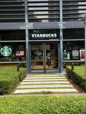 a starbucks building with stairs in front of it at Arcoris SOHO Mont Kiara 2B2B, Home Stay in Kuala Lumpur