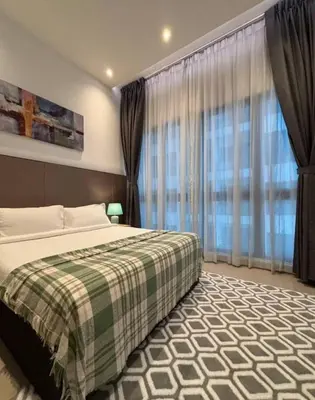a bedroom with a bed and a large window at The Colony By Infinitum L in Kuala Lumpur