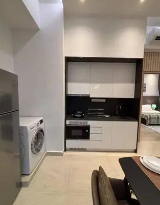 a kitchen with a stove and a washing machine at The Colony By Infinitum L in Kuala Lumpur