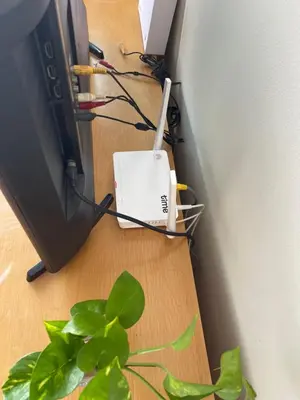 a computer on the floor next to a plant at Kuala lampur city centre in Kuala Lumpur