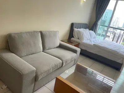 a living room with a couch and a bed at Kuala lampur city centre in Kuala Lumpur