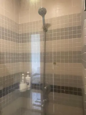 a shower with a shower head in a bathroom at Kuala lampur city centre in Kuala Lumpur
