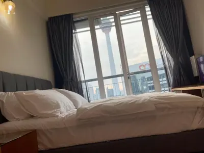 a bed in a room with a large window at Kuala lampur city centre in Kuala Lumpur