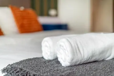 a stack of white towels sitting on a bed at Platinum 2km to KLCC Kuala Lumpur in Kuala Lumpur