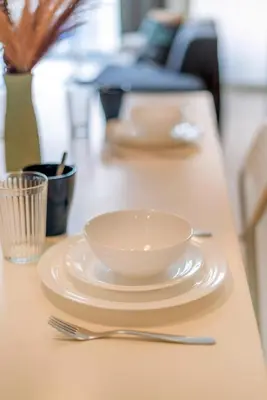 a white bowl and a fork on a table at Platinum 2km to KLCC Kuala Lumpur in Kuala Lumpur
