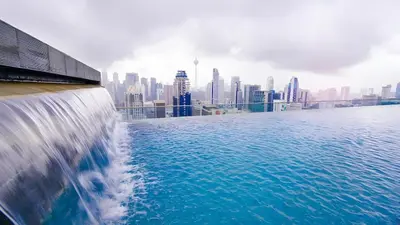 a view of a city skyline from a swimming pool at Regalia residence suite view in Kuala Lumpur