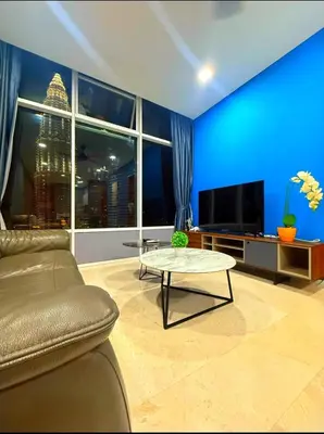 a living room with a couch and a tv at Luxury Home Stay by FNF suites in Kuala Lumpur