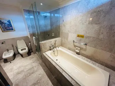 a bathroom with a shower and a tub and a toilet at Holiday Residence at times square kL in Kuala Lumpur