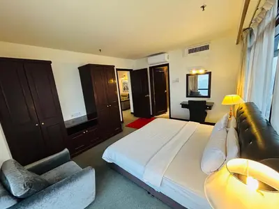 a large bedroom with a large bed and a couch at Holiday Residence at times square kL in Kuala Lumpur