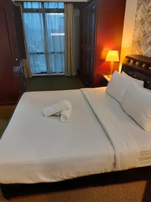 a hotel room with a bed with a towel on it at Homestay suite at times square KL in Kuala Lumpur