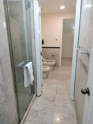 a bathroom with a toilet and a glass shower stall at Homestay suite at times square KL in Kuala Lumpur