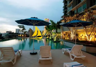 a group of chairs and umbrellas next to a swimming pool at Central 1BR Merdeka 118 View in Kuala Lumpur
