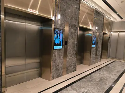 a elevator in a building with a tv on the wall at Bukit Bintang Agile Residence TRX in Kuala Lumpur