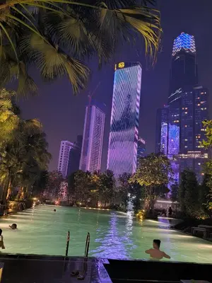 a swimming pool with a city skyline at night at Bukit Bintang Agile Residence TRX in Kuala Lumpur