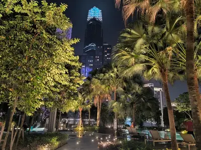 a city at night with palm trees and a building at Bukit Bintang Agile Residence TRX in Kuala Lumpur