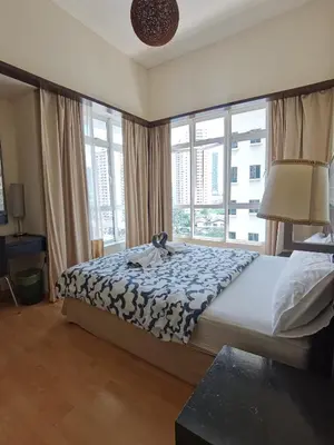 a bedroom with a bed with a blue and white blanket at Seri Bukit Ceylon Apartment Bukit Bintang in Kuala Lumpur