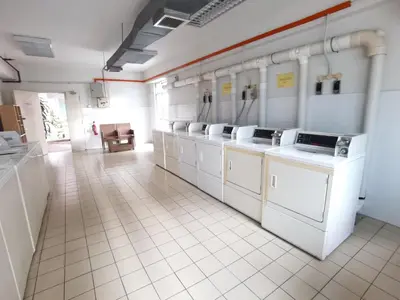 a large kitchen with white washers and sinks at Seri Bukit Ceylon Apartment Bukit Bintang in Kuala Lumpur