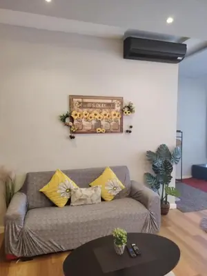 a living room with a couch and a table at Regalia residence suite view in Kuala Lumpur