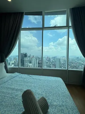 a bedroom with a bed and a large window at Nest In The Sky in Kuala Lumpur
